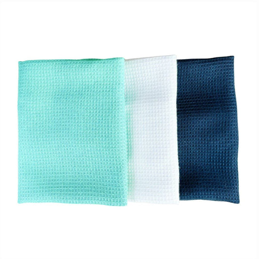 Three waffle-textured cloths in green, white, and blue on a white background