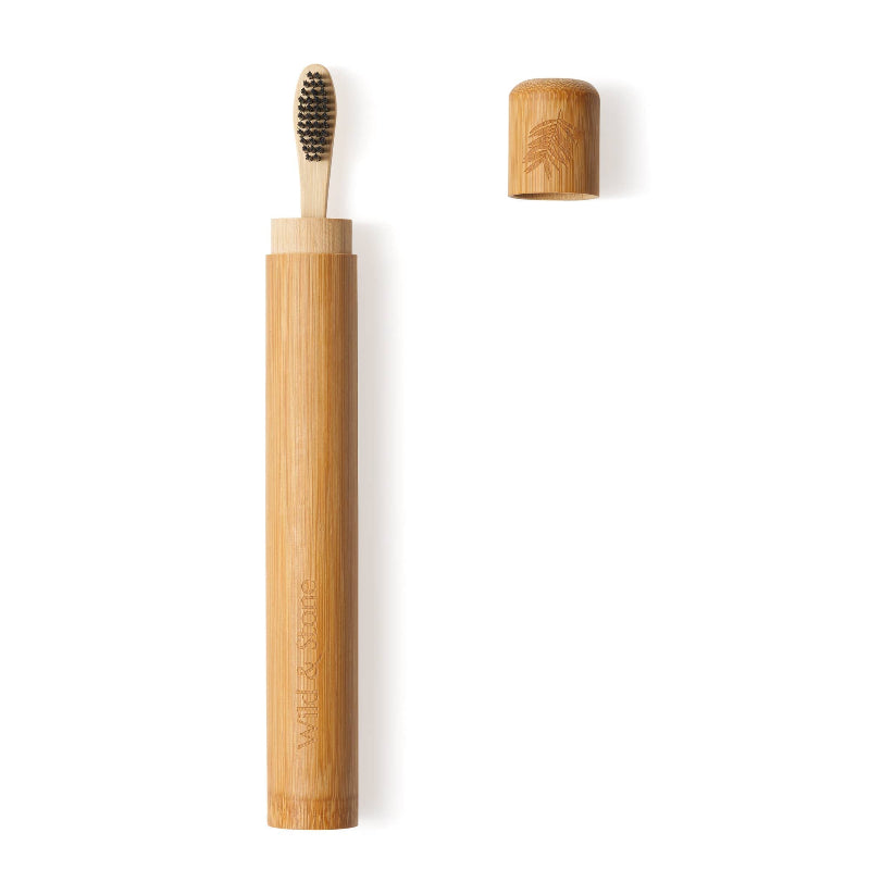 Bamboo toothbrush with holder on a white background