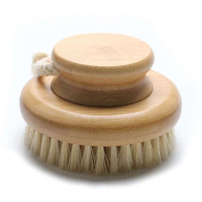 Wooden body brush with bristles on a white background