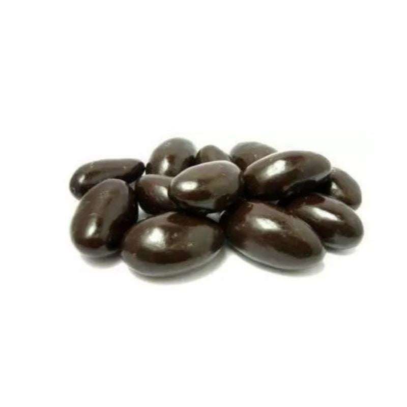 Dark chocolate coated Brazil nuts on a white background