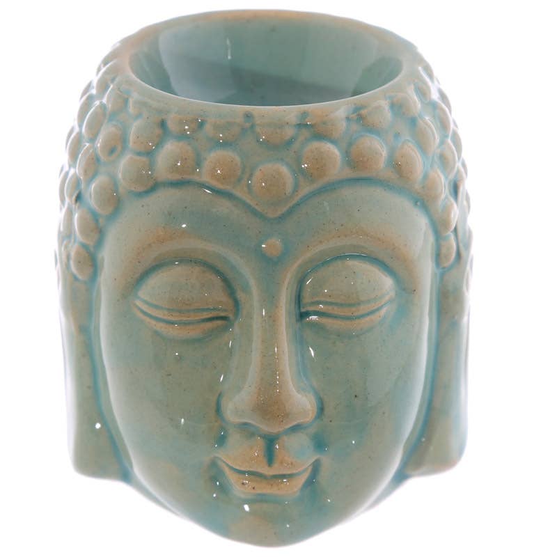 Ceramic wax melter shaped like a Buddha face on a white background