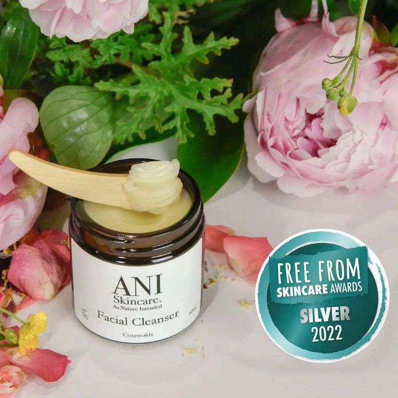 ANI Skincare Facial Cleanser jar with a wooden applicator on a floral background, featuring a Silver 2022 award badge.