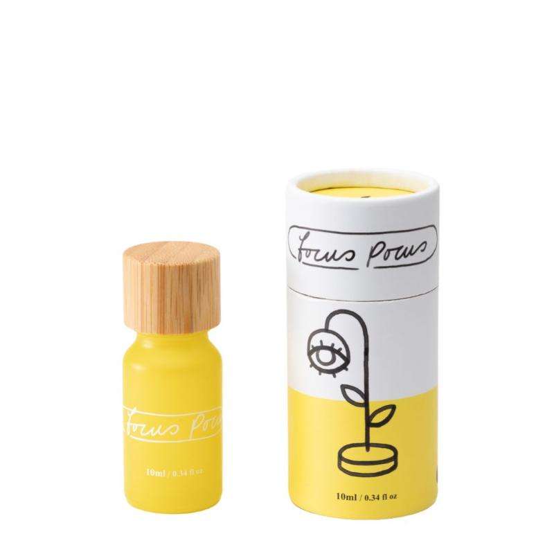 Yellow bottle with wooden cap and cylindrical white container with black text on a white background