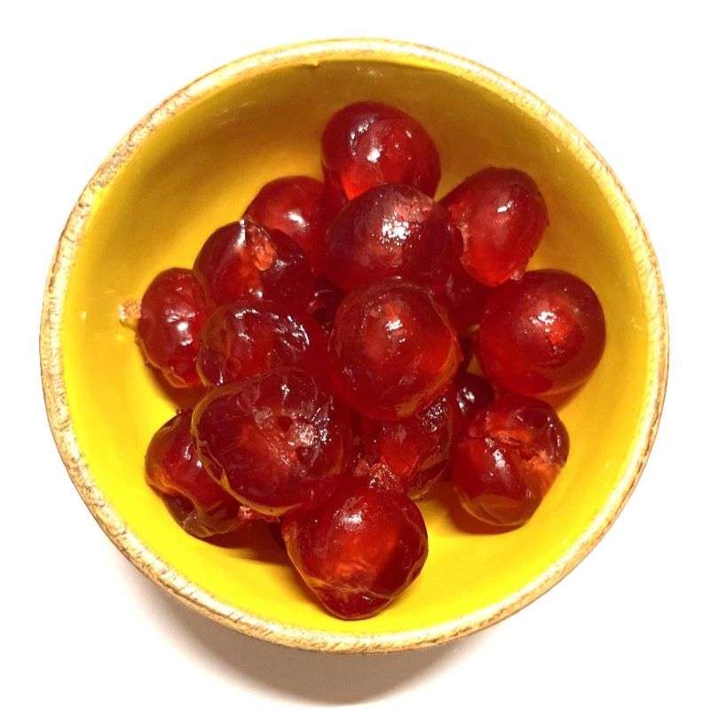 Glaced Red Cherries (per 300g) in a yellow bowl, glossy and vibrant red, perfect for baking or snacking.