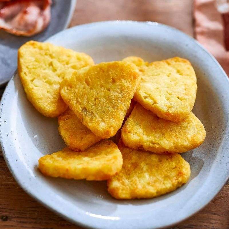 Heart-shaped yellow cookies on a white plate with a blurred background