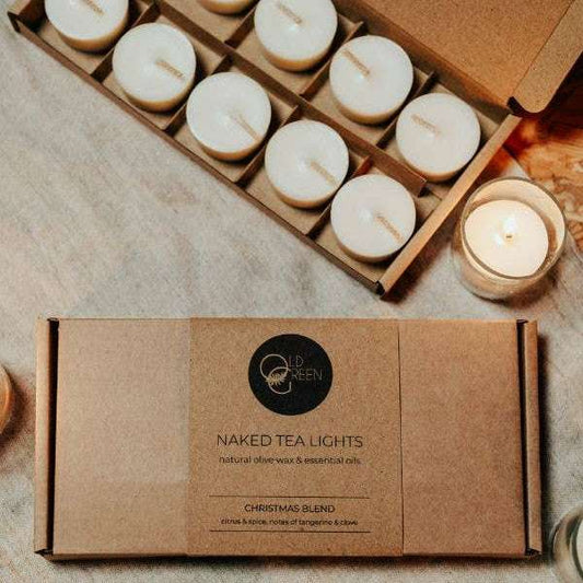 Naked tea lights in a cardboard box on a textured surface
