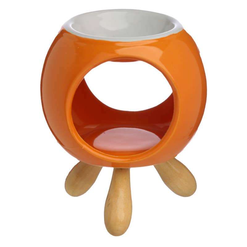 Orange wax melter with wooden legs on a white background