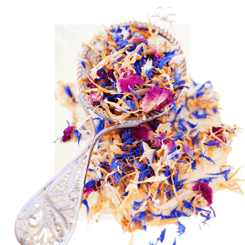 Close-up of colorful dried botanical flowers in a decorative spoon showcasing Dried Botanical Flowers (50g) for natural skincare use.