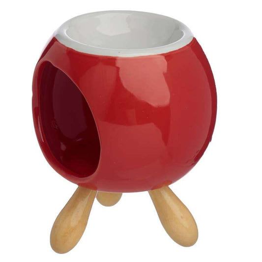 Red ceramic pot with white interior on a wooden stand against a white background