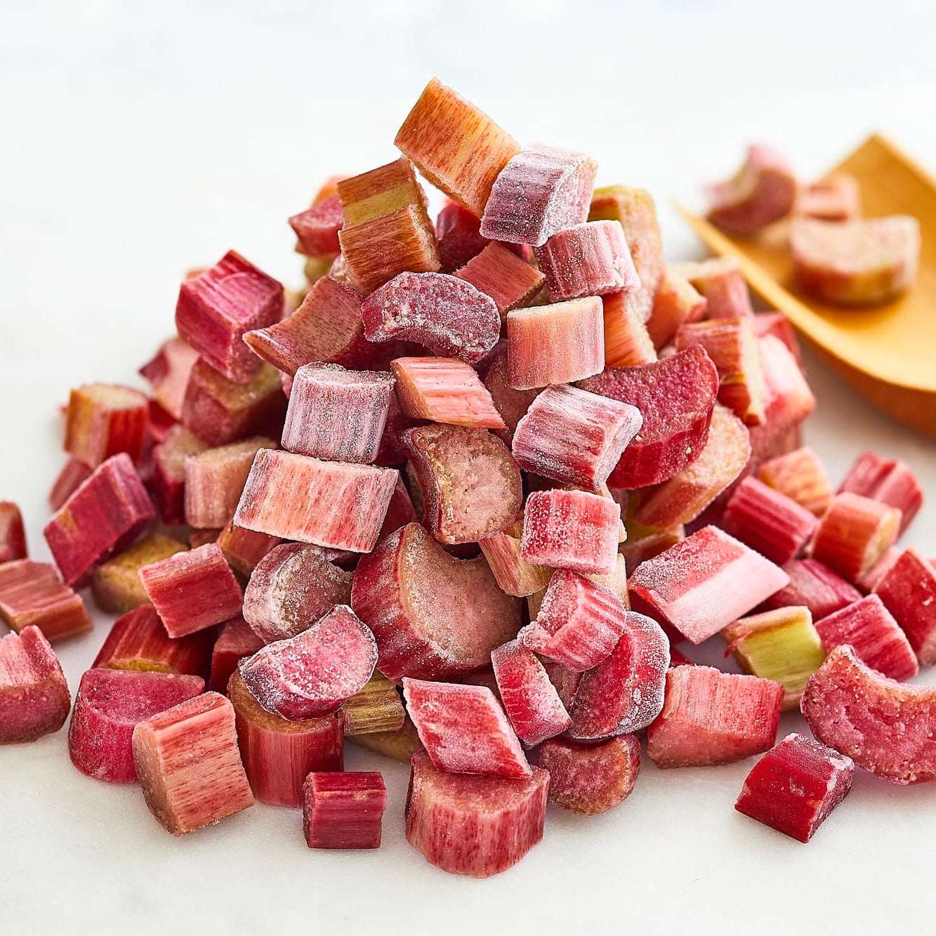 Frozen rhubarb pieces on a white background