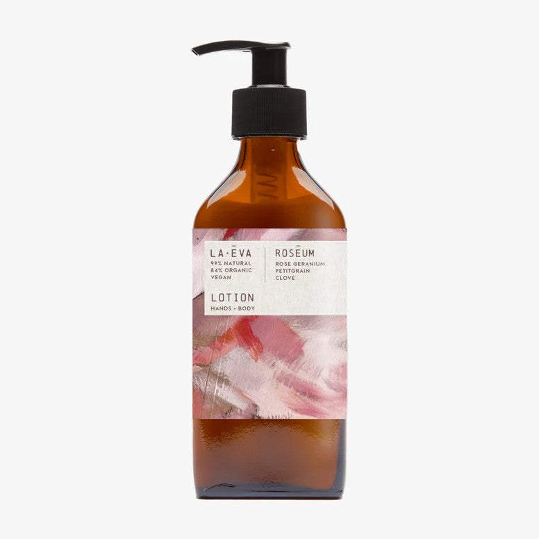 A brown bottle with a pump dispenser labeled 'ROSÉUM' for face and body wash, with a pink and purple floral design.