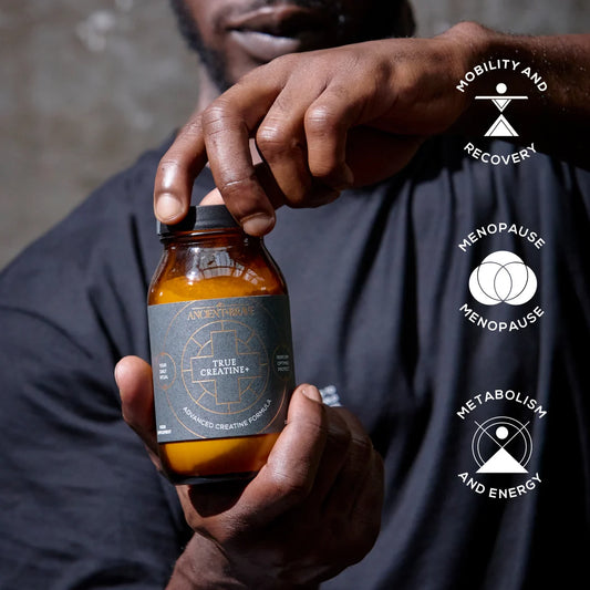 Person holding a bottle labeled 'True Creatine' with health benefits icons on a dark background