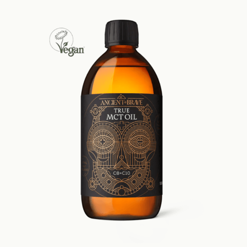 Amber bottle of True MCT Oil with black cap and detailed gold label, vegan and ethically produced natural product.