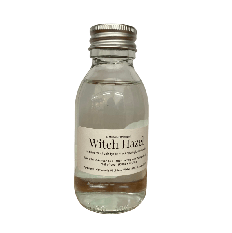Clear glass bottle with metal cap containing Witch Hazel natural astringent for skincare use