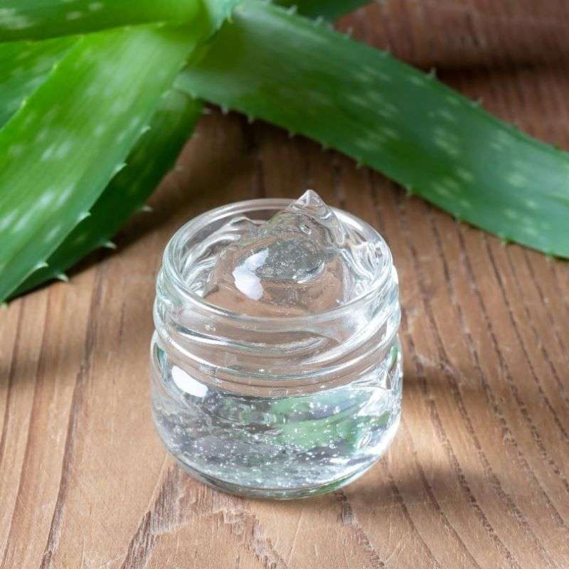 Clear gel in a jar with fresh aloe vera leaves on a wooden surface, natural skincare Aloe Vera Gel (60ml)