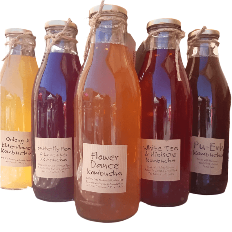 Variety of colorful Kombucha bottles with natural flavors in reusable glass containers at a refill shop