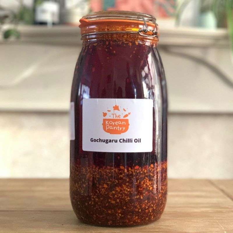 A glass jar of Korean Gochugaru Chilli Oil with a label showing 'Korean Pantry' branding.