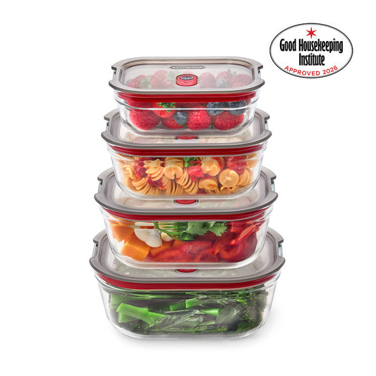 A stack of four clear glass food storage containers with gray lids and red seals, filled with various fruits, vegetables, and pasta, shown on a white background with a Good Housekeeping Institute Approved 2026 badge in the top right.