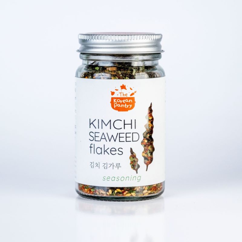 Glass jar of Kimchi Seaweed Flakes (40g) seasoning with a silver lid on a white background