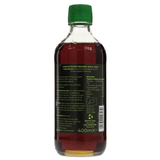 Bottle of concentrated organic apple juice with a green cap on a white background