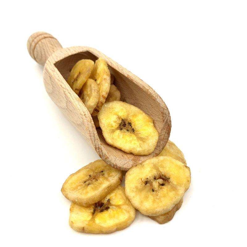 Banana Chips ORGANIC (per 300g) displayed in a wooden scoop with some chips spilled on a white background.