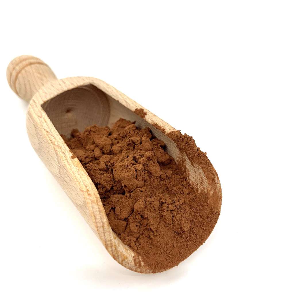 Wooden scoop filled with Cocoa Powder (10-12% fat) ORGANIC (per 300g) on a white background