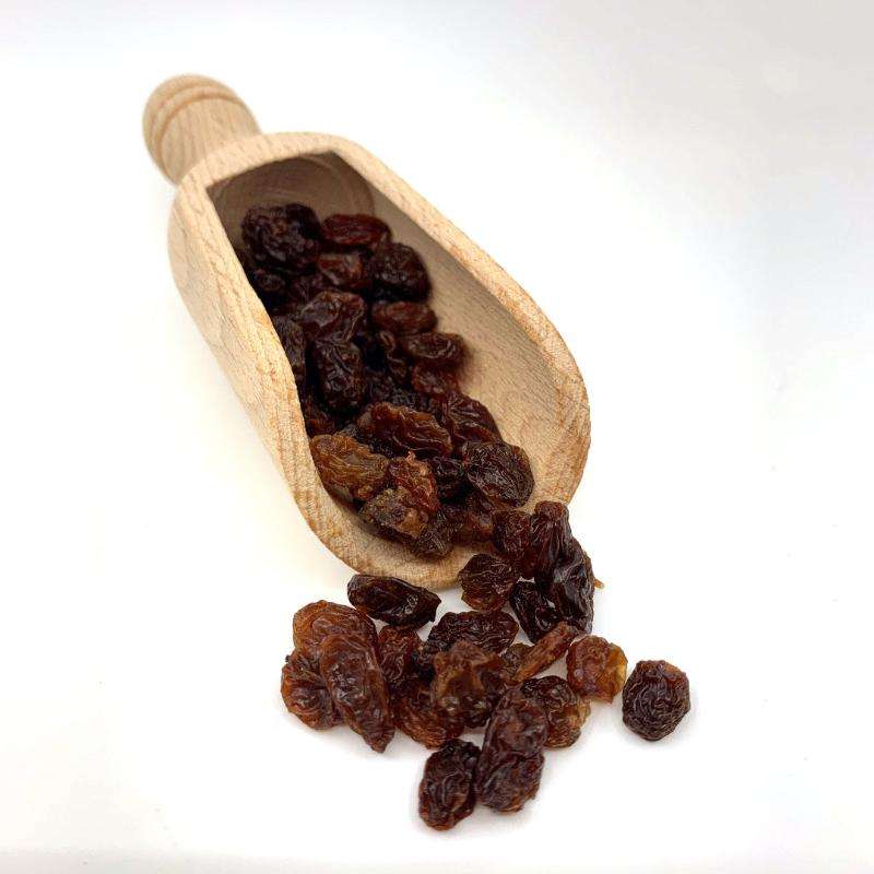 Raisins ORGANIC (per 500g) displayed in a wooden scoop, showcasing natural and healthy organic food option.
