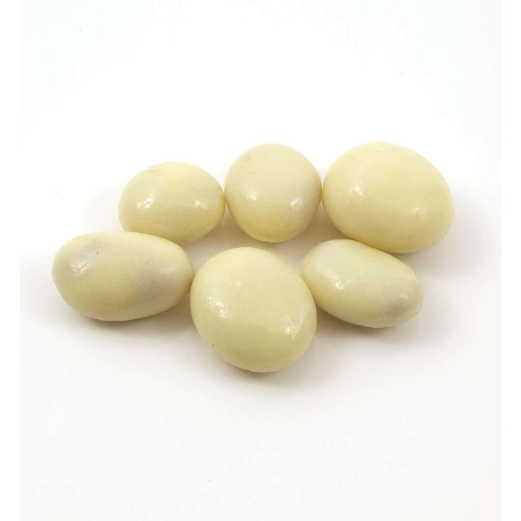 A group of yogurt-coated raisins on a white background.