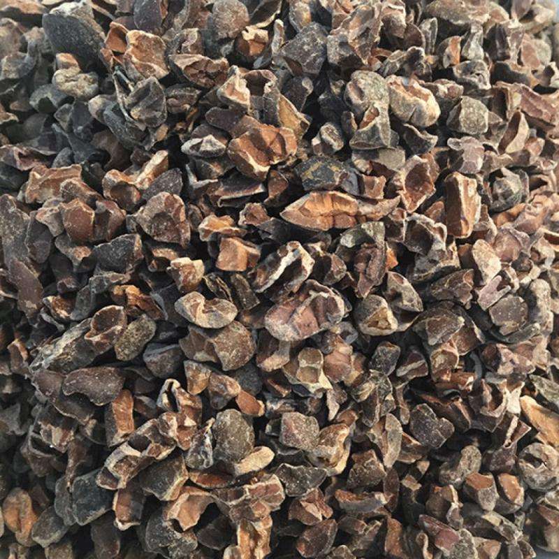 Close-up of natural Raw Cacao Nibs ORGANIC (per 100g) showing unprocessed, plant-based organic food pieces.