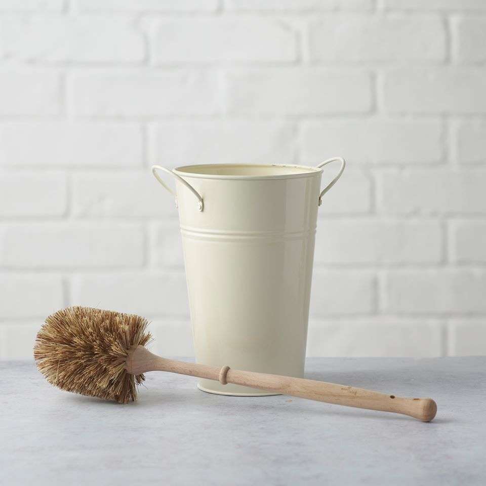 Plastic Free Toilet Brush & Holder (FSC 100%) with natural bristles and a cream-colored metal holder on a gray surface