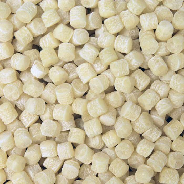 Close-up of small textured beige grains resembling pasta in Fregola (Giant Couscous) ORGANIC (per 500g) packaging.