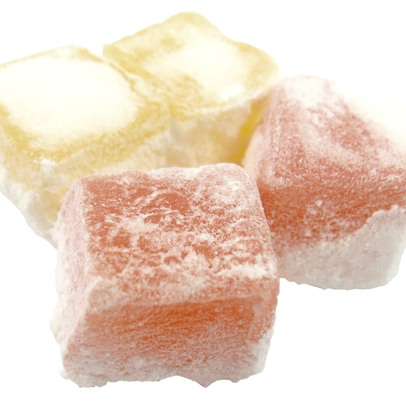 Three colorful pieces of Turkish Delight VEGAN (per 100g) dusted with powdered sugar on white background
