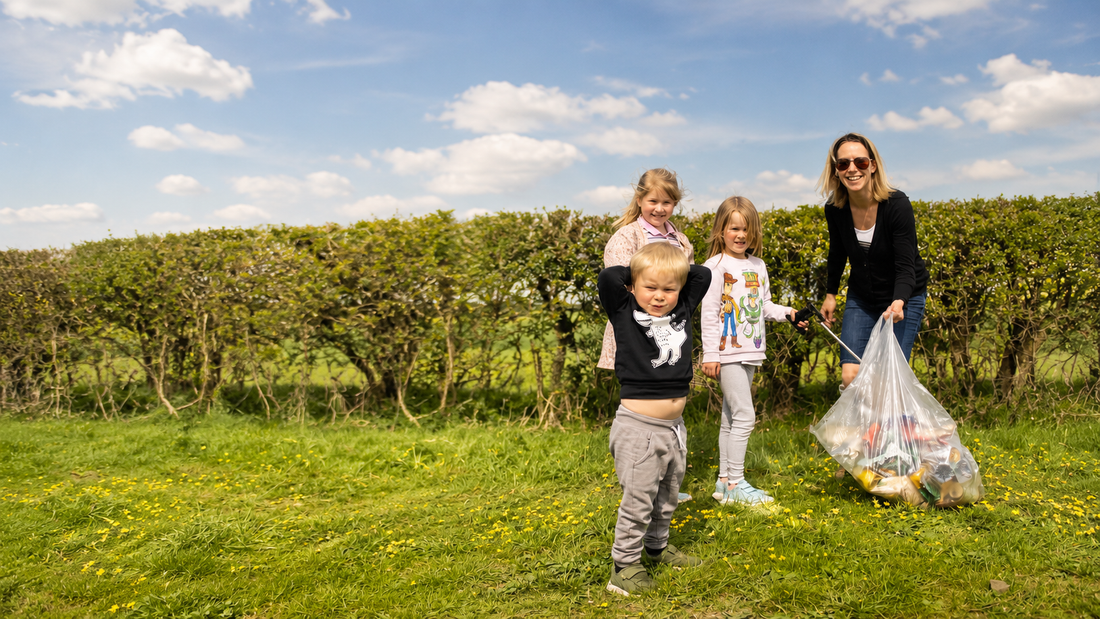 Local family taking part in a litter pick, collecting rubbish from a countryside footpath in Oxfordshire.