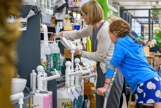 Customers refilling reusable bottles at The Village Refill in Yarnton Home & Garden during Plastic Free July.