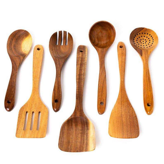Set of wooden kitchen utensils including spoons and spatulas on a white background