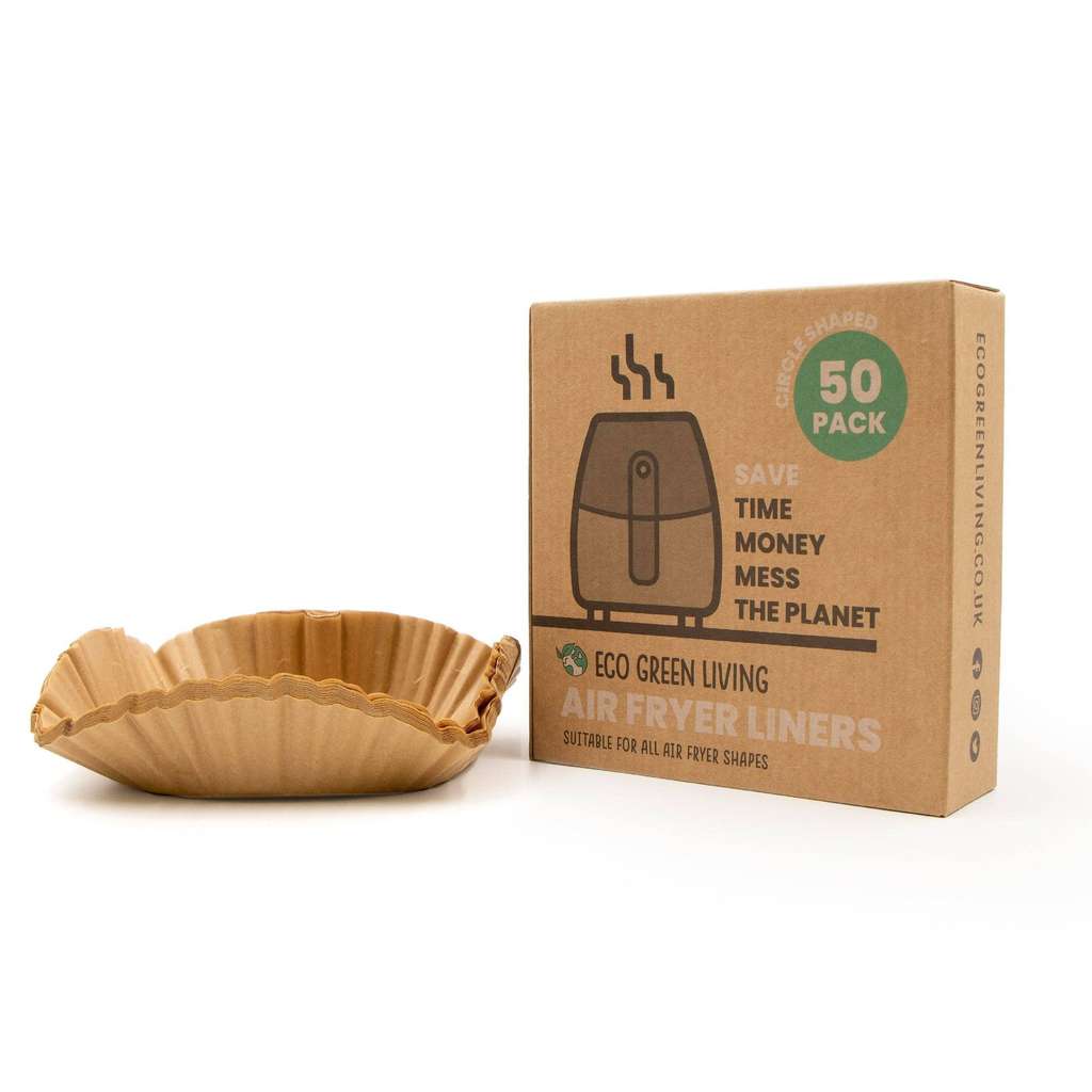 Paper air fryer liner next to a cardboard box with text on a white background