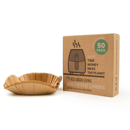 Paper air fryer liner next to a cardboard box with text on a white background