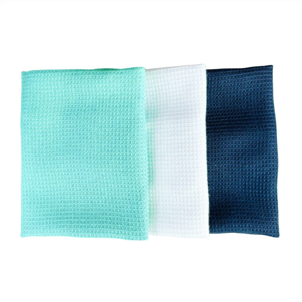 Three waffle-textured cloths in green, white, and blue on a white background