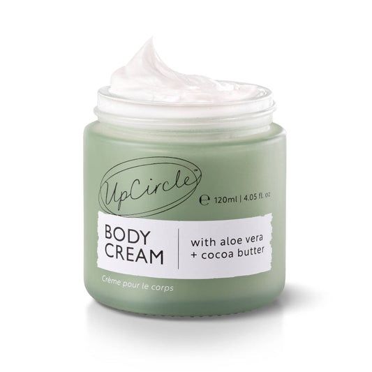 UpCircle body cream jar with a white label on a white background