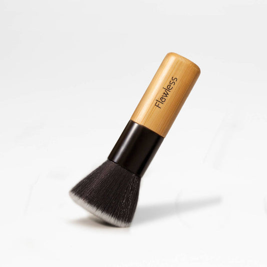 Makeup brush with wooden handle and black bristles on a white background