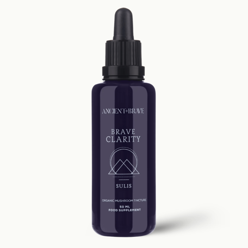 Navy blue bottle with black cap labeled 'Brave Clarity' on a white background