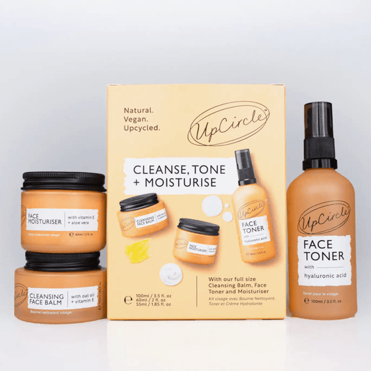 UpCircle skincare products including face toner, cleansing balm, and face moisturizer on a white background.