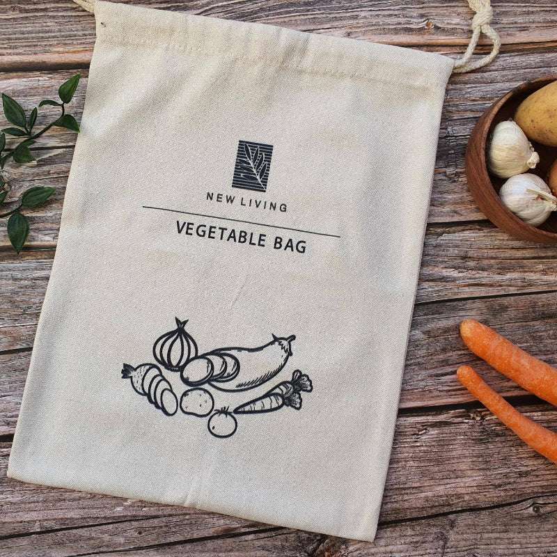 Cotton Bag with 'New Living' logo on a wooden surface with vegetables.