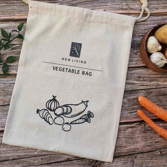 Cotton Bag with 'New Living' logo on a wooden surface with vegetables.
