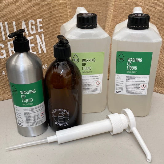 Set of The Village Refill  washing up liquid bottles and a pump on a countertop.