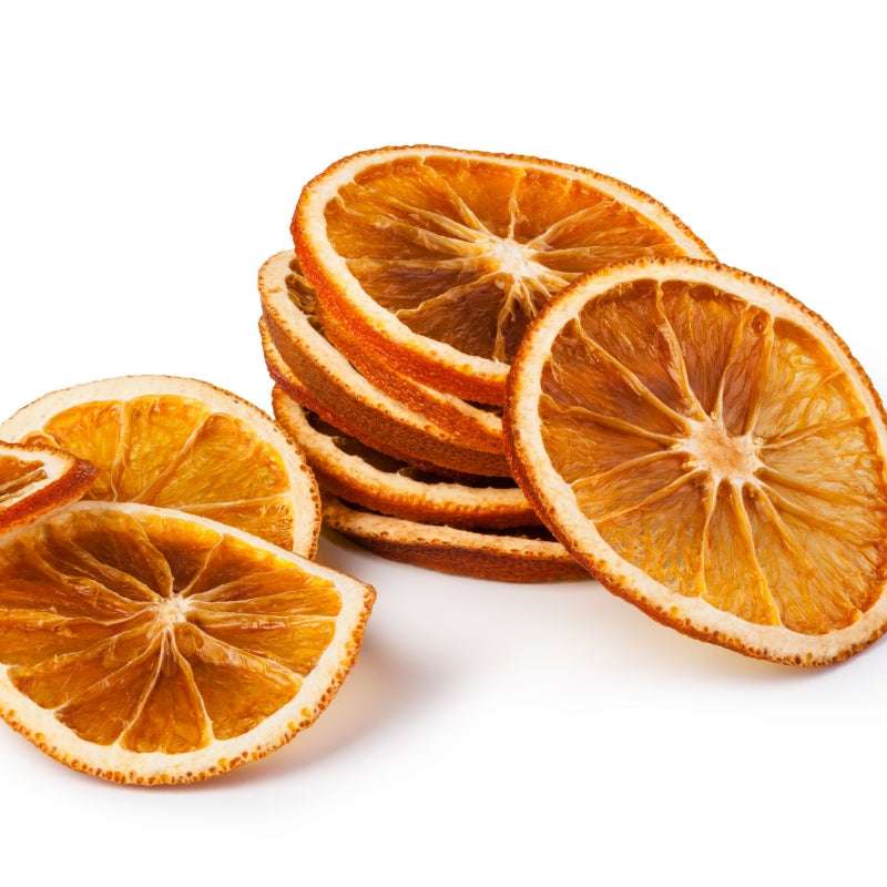 Natural Dried Orange Slices stacked in a pile showcasing, plastic free, plant-based dried fruit food.