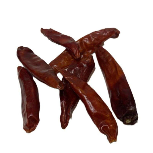 Dried red whole chillies arranged on white background for Chilli Whole (per 100g) packaging display