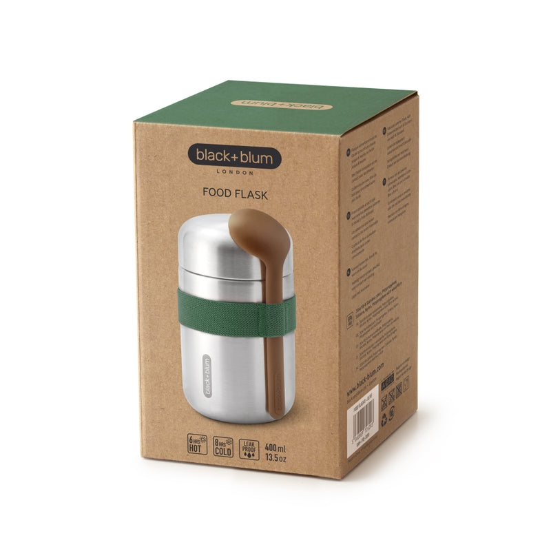 Cardboard packaging of a food flask with a green lid and spoon holder, featuring the brand 'black+blum'.