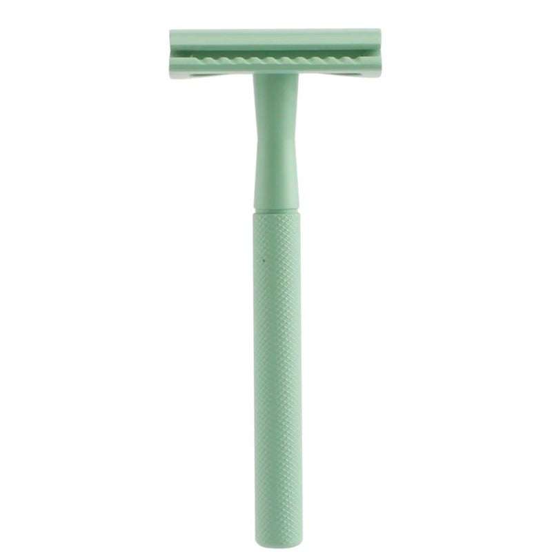 Green safety razor on a white background