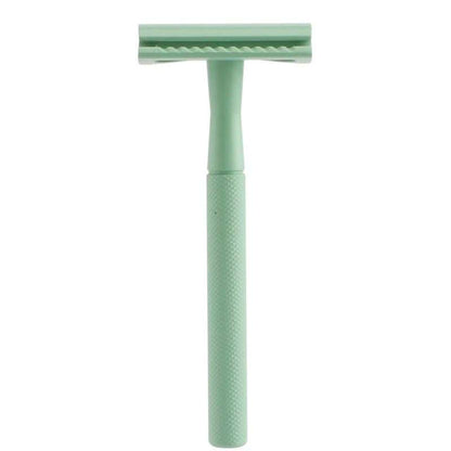 Green safety razor on a white background